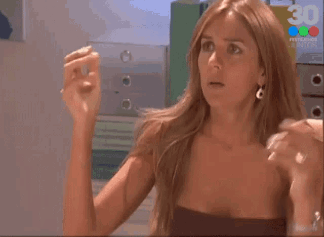 a woman is sitting in front of a tv screen that says 30