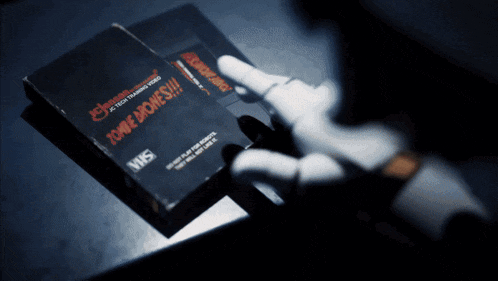 a person is holding a vhs tape that says tongue bones on it