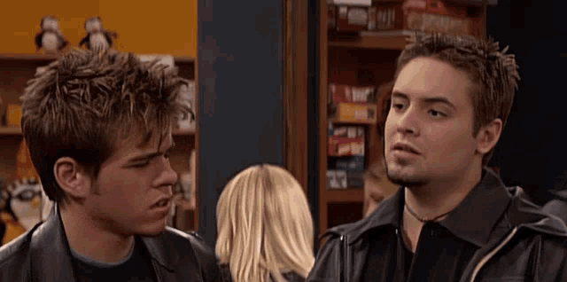 two men are standing next to each other and one of them is wearing a black shirt