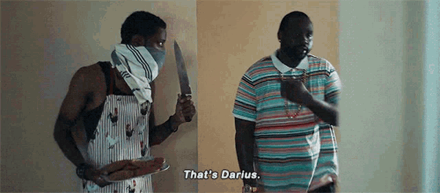a man with a bandana on his face is holding a knife while another man says " that 's darius "