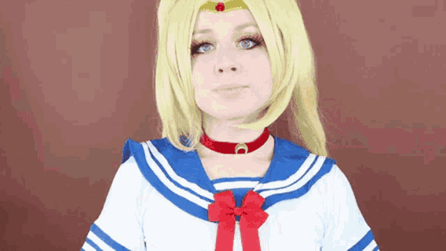 a woman in a sailor moon costume is making a funny face