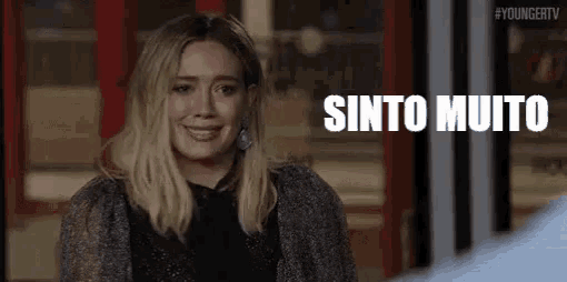 a woman is smiling and looking at the camera with the words sinto muito written in the background .