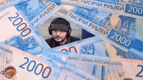 a man wearing headphones sits on a pile of 2000 russian ruble bills