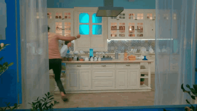 a kitchen with white cabinets and a stove top oven