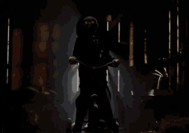a person is riding a bike in the dark with red eyes