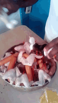 a plate of food with chicken wings carrots and hot dogs on it