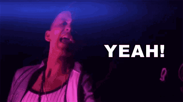 a man is singing into a microphone with the word yeah written in the background