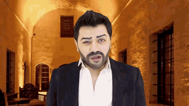 a man with a beard in front of a building