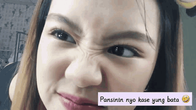 a close up of a woman 's face with the words pansinin nyo kase yung bata written below it