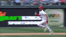 a baseball player is running on the field in front of a sportsbook ad