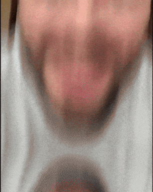 a blurry picture of a person 's face with a white shirt