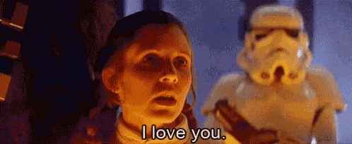 a woman is standing in front of a stormtrooper and saying `` i love you '' .