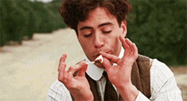 a man is eating a piece of cake with a spoon