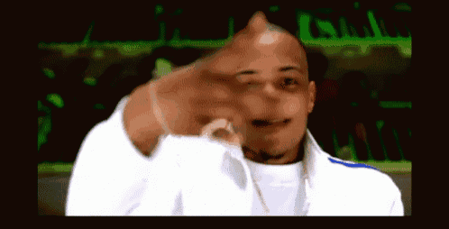 a man in a white jacket is pointing his finger