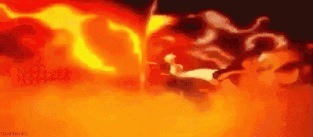 a person is standing in front of a large fireball .