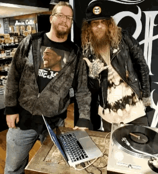 two men standing next to each other with one wearing a shirt that says ' rtg jm '