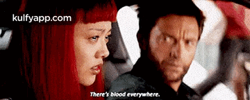 a man and a woman are sitting in a car and the woman is saying there is blood everywhere .