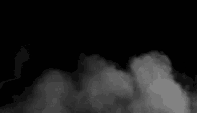 there is a lot of smoke coming out of the bottom of the screen on a black background .