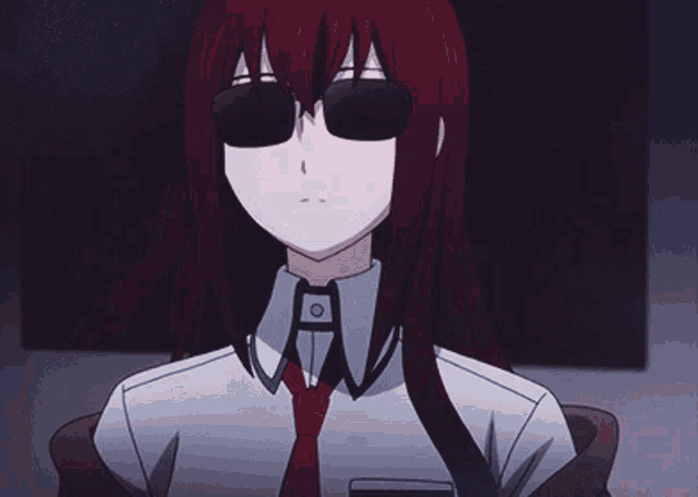 a girl with long red hair is wearing a red tie