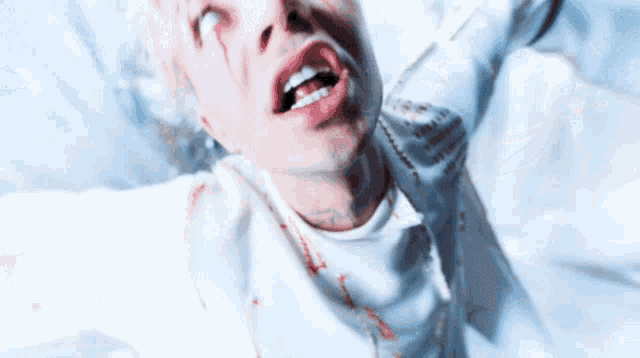 a man in a white jacket with blood on his face