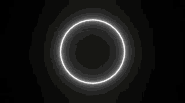 a white circle is shining in the dark