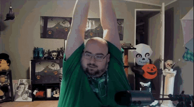 a man in a green shirt is stretching his arms