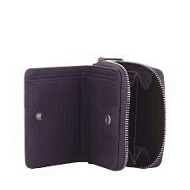 a black leather wallet is sitting on top of a pile of green plants .