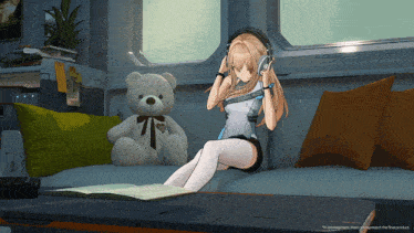 a girl wearing headphones sits on a couch next to a teddy bear and a book