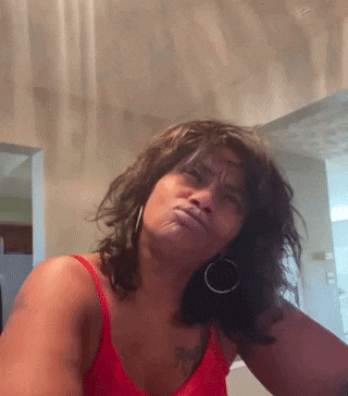 a woman in a red tank top has a tattoo on her arm that says ' i 'm sorry '