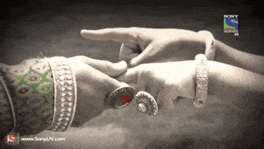 a black and white photo of a man and woman holding hands with sony television hd written on the bottom