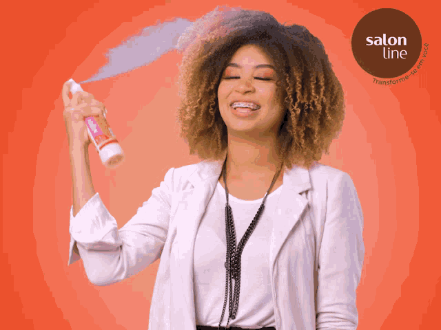 a woman spraying her hair with a salon line product