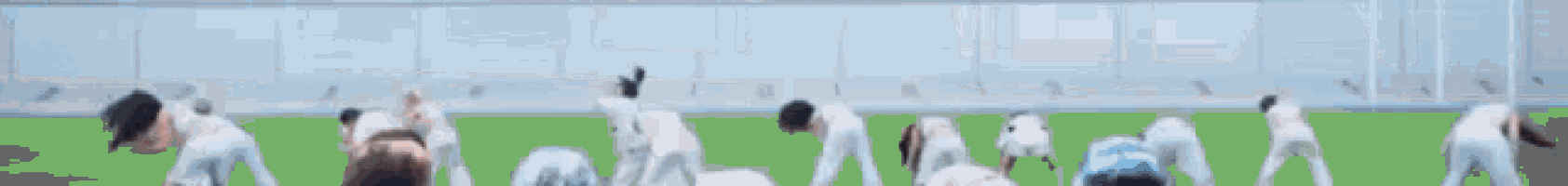 a blurry picture of a group of people standing on top of a soccer field .
