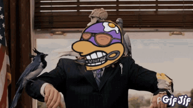 a man in a suit is surrounded by birds and a gif with the word gif jif on it