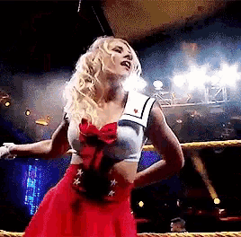 a woman in a sailor top and red skirt is standing in a boxing ring