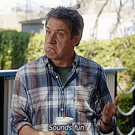 a man in a plaid shirt is holding a drink and saying sounds fun .