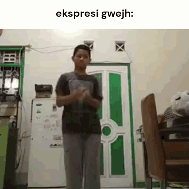 a young man is standing in a room with a green door .