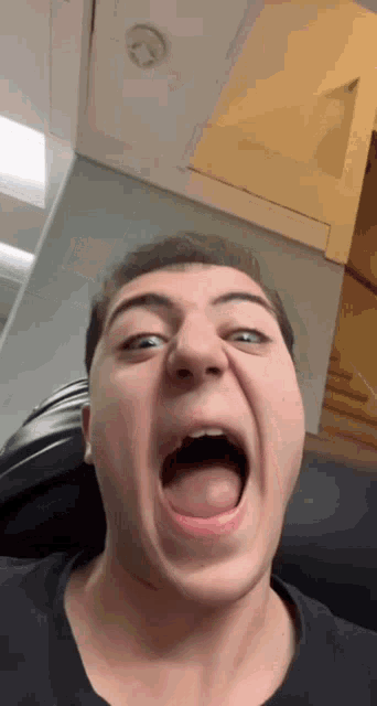 a man making a funny face with his mouth wide open