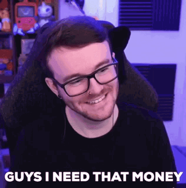 a man with glasses is sitting in a chair and smiling .