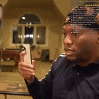 a man wearing a hat is taking a picture of himself with his phone