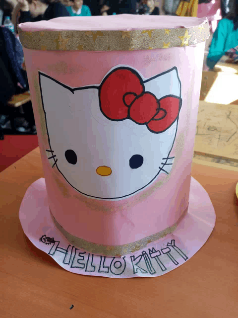 a pink top hat with a hello kitty design on it