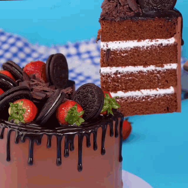 a chocolate cake with strawberries and oreo cookies on top