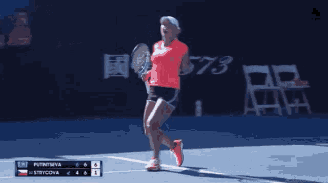 a woman is holding a tennis racquet on a tennis court with the scoreboard showing putintseva and strycova