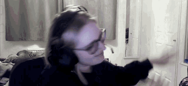 a person wearing headphones and glasses is dancing