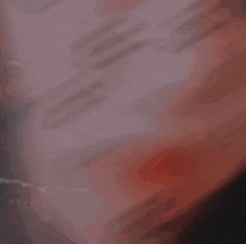 a blurry image of a person 's face with a purple background and a few letters on it