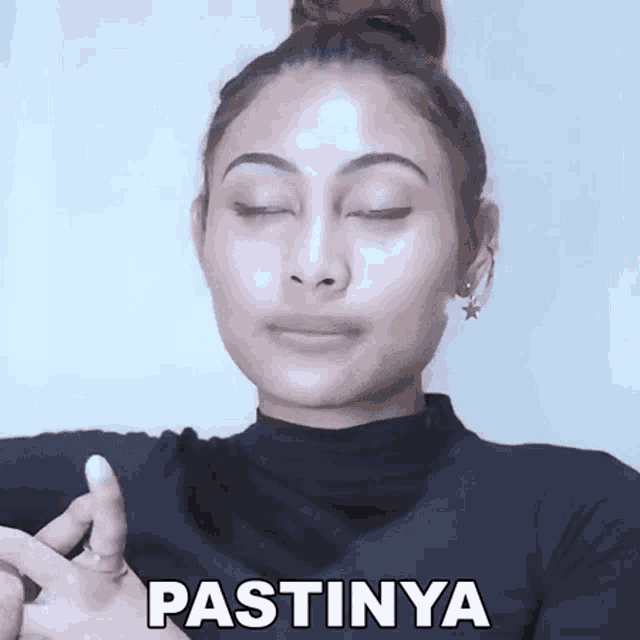 a woman with her eyes closed has the word pastinya written on her chest