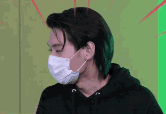 a man wearing a face mask is looking at the camera