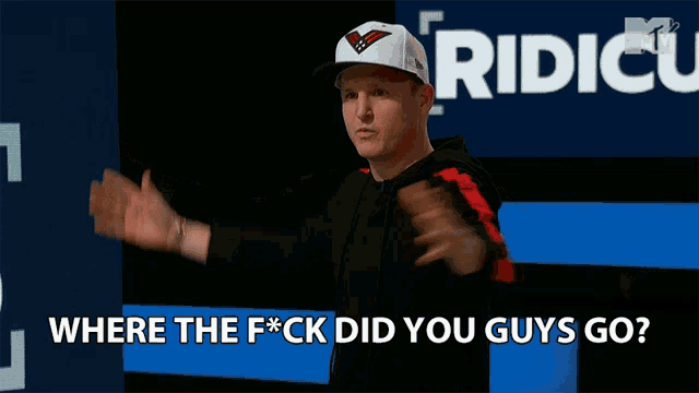 a man stands in front of a sign that says ridicu where the fuck did you guys go