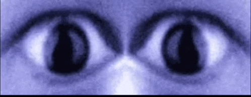 a close up of a person 's eyes in a blue background