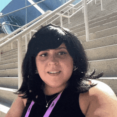 a woman wearing a lanyard that says ' jcpenney ' on it smiles for the camera