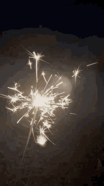 a bunch of sparklers are lit up in the night sky